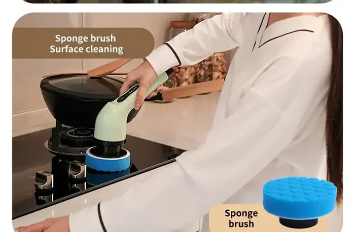 Sponge brush head cleaning a kitchen stovetop